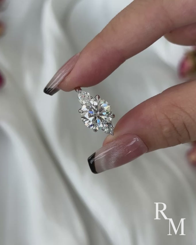 Moissanite 4.0 Ct Round Cut White Gold Engagement Ring with Pear Cut Side Stone