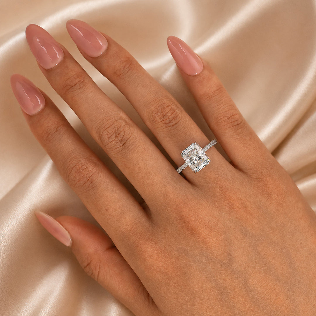 Yellow gold radiant cut engagement ring on hand