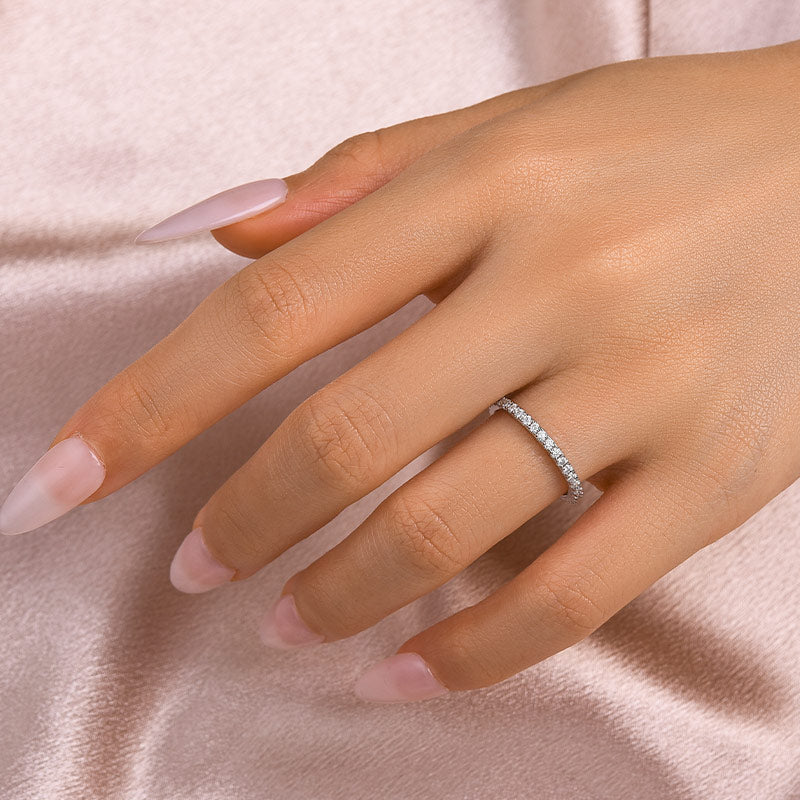 Thin moissanite full eternity band worn on hand