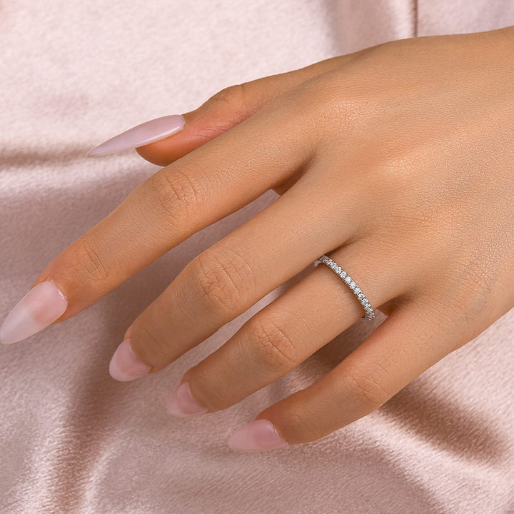 Thin moissanite full eternity band worn on hand