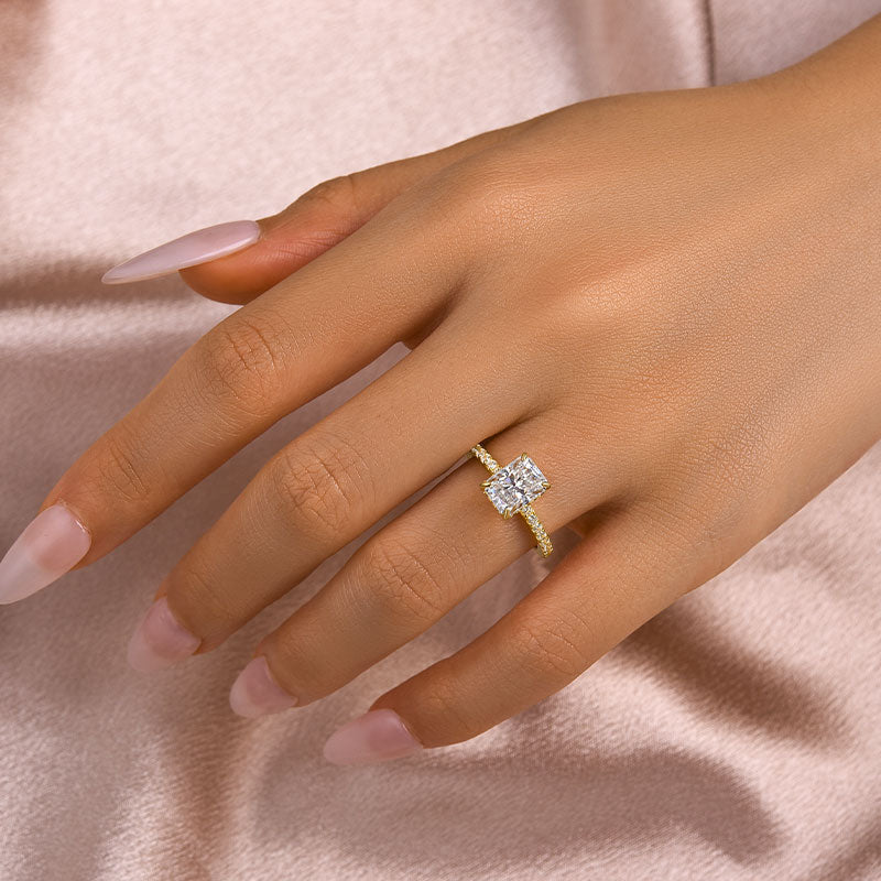 Yellow gold radiant cut moissanite engagement ring worn on hand