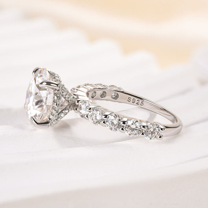 Side view of round moissanite engagement ring showing the raised 4-prong setting