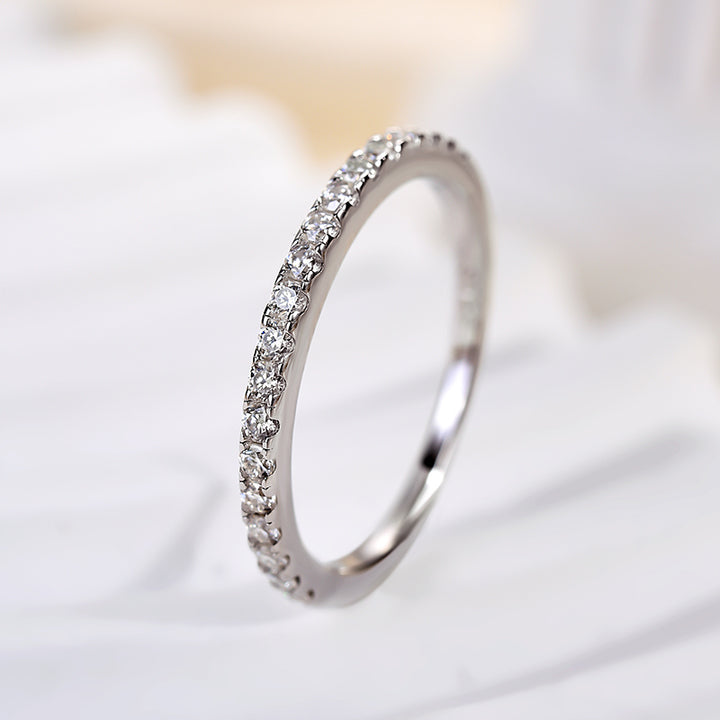 Side profile of the half halo moissanite ring and slim silver band