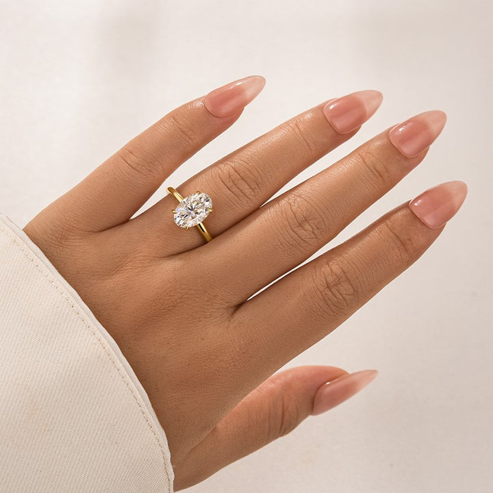 Oval moissanite promise ring styled on hand for everyday wear