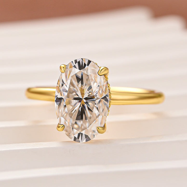 Front view of a 3.0 ct oval moissanite ring with yellow gold band
