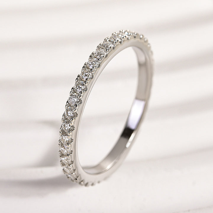 Side view of a thin round stone moissanite eternity band