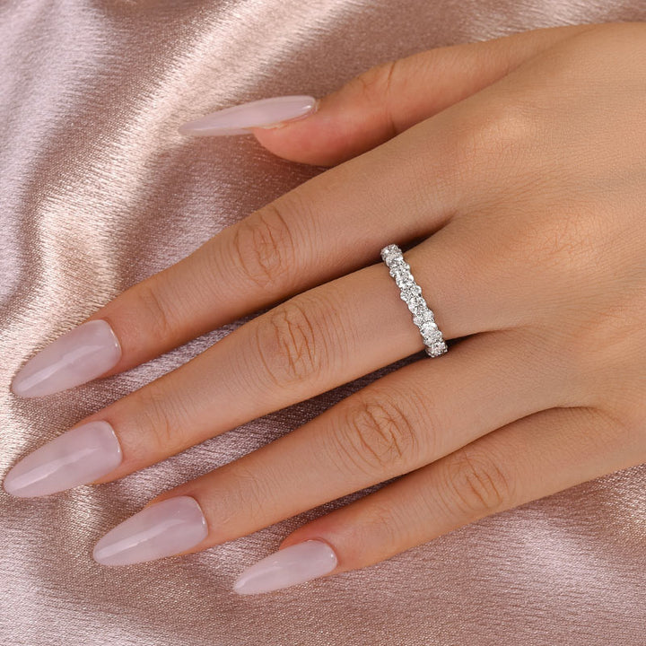 White moissanite full eternity wedding band worn on hand