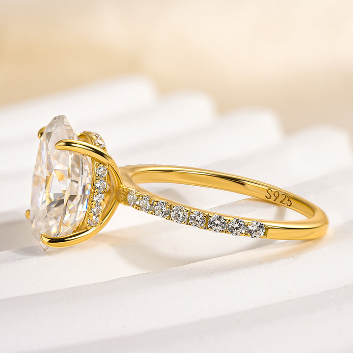 Side profile of an oval moissanite ring with pavé side stones