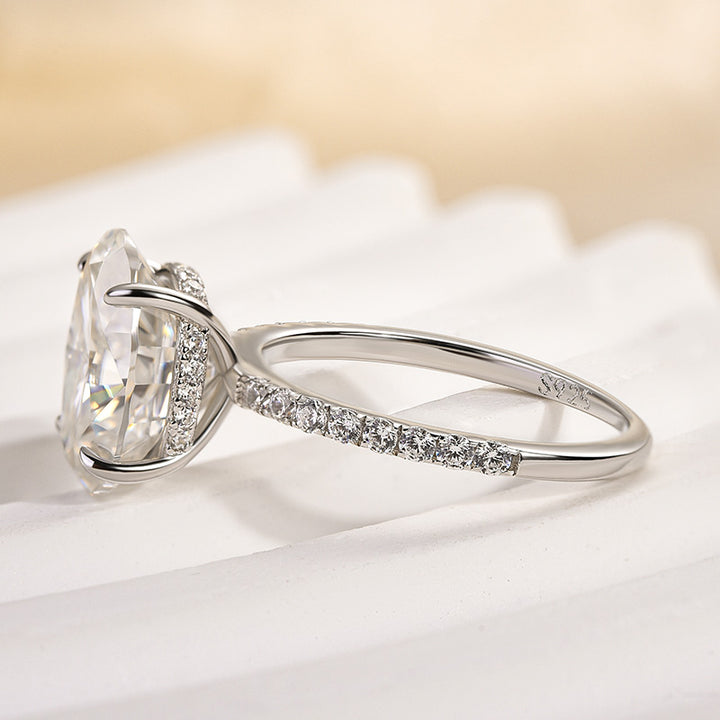 Side profile of a white gold pavé oval moissanite ring