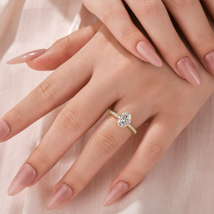 Yellow gold oval moissanite promise ring worn on hand