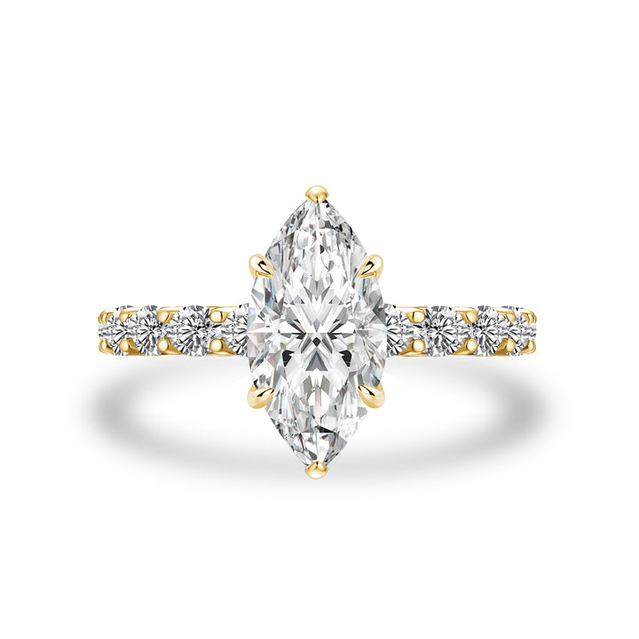 White marquise side stone engagement ring in yellow gold