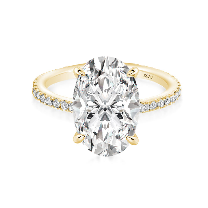 Oval moissanite half eternity engagement ring in yellow gold